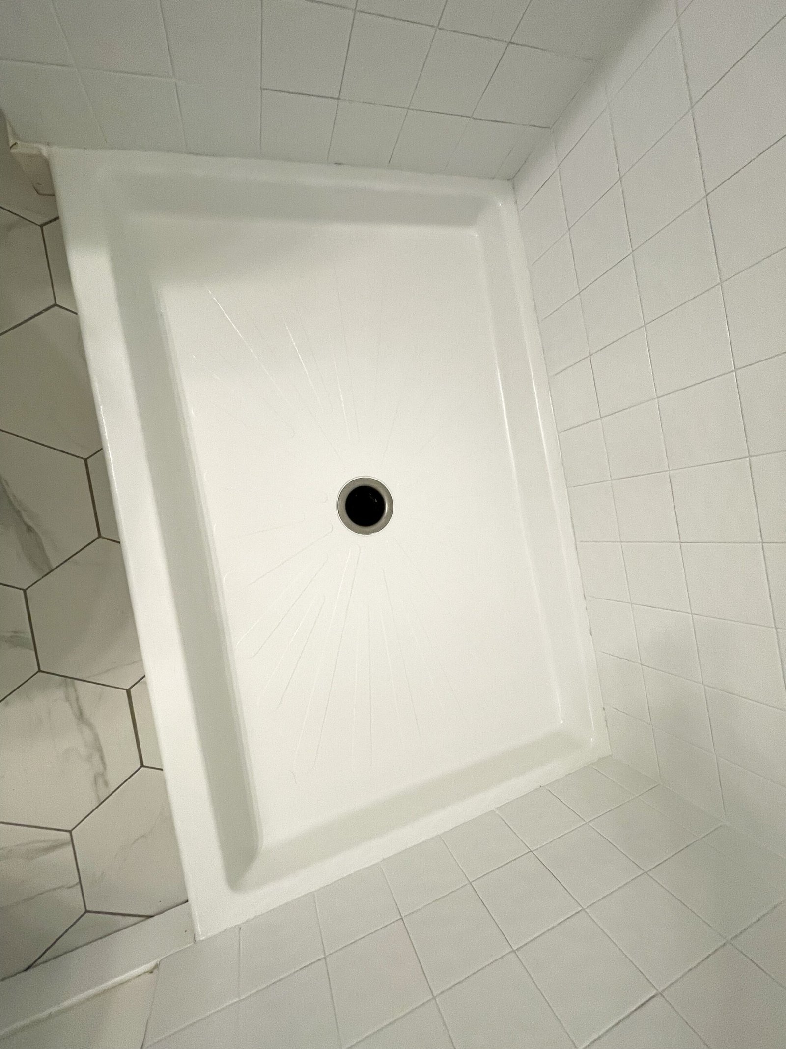 Shower refinishing services with newly reglazed white shower pan